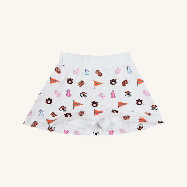 The Beaufort Bonnet Company’s Auburn Searcy Skort - Tiger Thrill with Worth Avenue White is a white children’s skort featuring Auburn University-themed logos, pennants, paw prints, cheer megaphones, and tigers in vibrant orange, navy, and pink—a sporty gameday outfit choice.