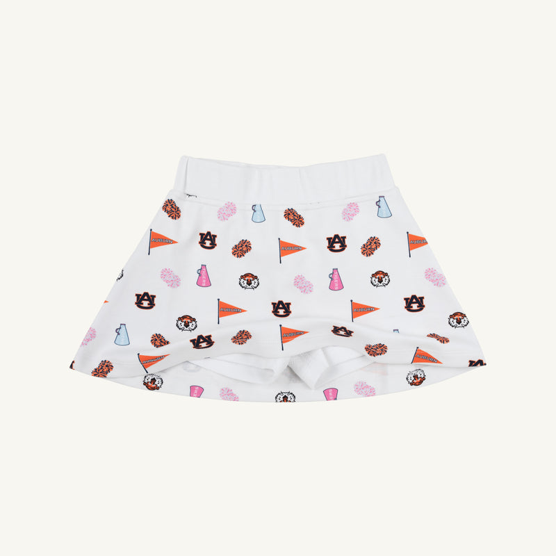 The Beaufort Bonnet Company’s Auburn Searcy Skort - Tiger Thrill with Worth Avenue White is a white children’s skort featuring Auburn University-themed logos, pennants, paw prints, cheer megaphones, and tigers in vibrant orange, navy, and pink—a sporty gameday outfit choice.