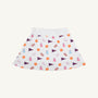 The Beaufort Bonnet Company’s Clemson Searcy Skort - Tiger Triumph with Worth Avenue White features a white, sporty skort with an elastic waistband, playfully patterned with orange paw prints, purple pennants, pink megaphones, and light blue bottles in a repeating design.