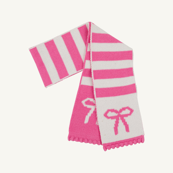 The Beaufort Bonnet Company’s Seller’s Scarf in Hamptons Hot Pink & Palmetto Pearl Stripe with Bows features alternating pink and white stripes adorned with delicate bow designs and scalloped edges. This cotton knit scarf is a cozy and stylish accessory, perfect for girls to wear on chilly days.