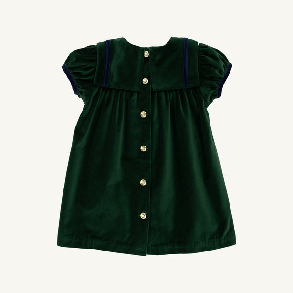 Here’s a rewritten version using your product data: The Beaufort Bonnet Company’s Short Sleeve Patsy’s Party Dress in Grier Green Velveteen with Nantucket Navy, a holiday dress for children, features short puff sleeves, a wide collar trimmed in navy, and a row of gold buttons down the back, displayed on a plain white background.