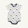 Dress your little one for game day in the Michigan Short Sleeve Patton Play Bubble - Bold in Blue with Michigan Blue by The Beaufort Bonnet Company. This adorable white baby romper is made from soft Pima Cotton Knit and features short sleeves, navy trim on the collar, sleeves, and leg openings, and a playful design with repeating University of Michigan logos, blue “M” letters, yellow flags, and “Wolverines” text—making it the perfect outfit for your future fan!.