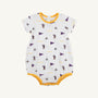 The LSU Short Sleeve Patton Play Bubble - Tenacious Tigers with LSU Gold by The Beaufort Bonnet Company is a white baby romper made from soft Pima Cotton, featuring short sleeves, yellow trim, and a playful all-over print of small tigers, purple pennants, and the word “TIGERS” in yellow throughout the fabric. Part of our Tenacious Tigers collection.