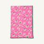 The Silent Night Throw - Bows of Holly with Kiawah Kelly Green by The Beaufort Bonnet Company features a charming pattern of white and pink flowers with green leaves, bordered by a solid green edge, and is crafted from soft Pima Cotton Knit for added comfort.