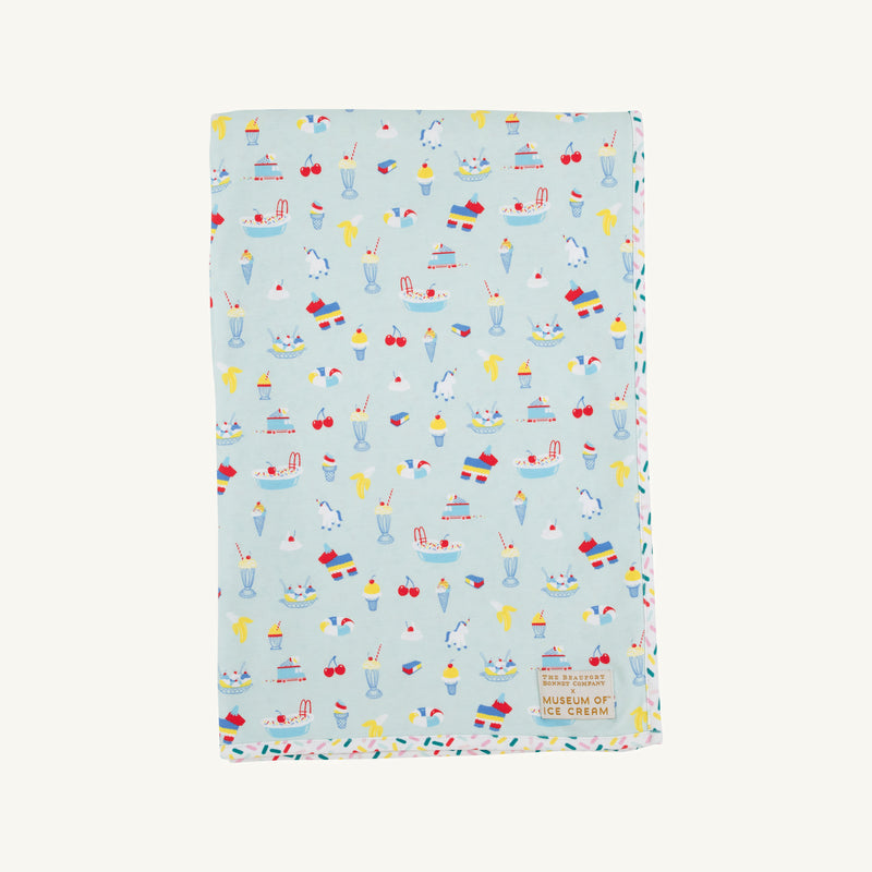 Introducing the Silent Night Throw - Ice Cream Daydream (Blueberry Blue) from The Beaufort Bonnet Company—a light blue throw featuring colorful, playful ice cream, drink, and cherry illustrations with a small label in the bottom corner. Perfect as a cheerful ice cream print throw!.