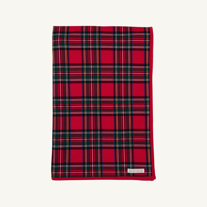 A folded Silent Night Throw - Society Prep Plaid blanket in a red, green, and white plaid pattern with a solid red border.