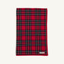 A folded Silent Night Throw - Society Prep Plaid blanket in a red, green, and white plaid pattern with a solid red border.