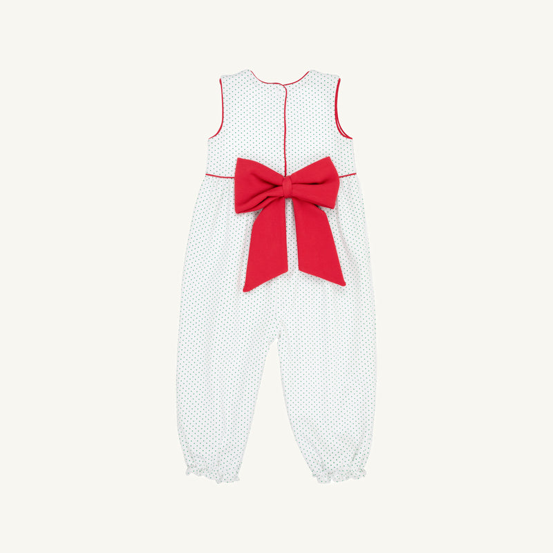 The Sleeveless Rebecca Romper - Kiawah Kelly Green Microdot with Richmond Red by The Beaufort Bonnet Company features a charming green microdot pattern, bright red piping, and a large red bow at the back. Made from soft Pima cotton, this delightful children’s jumpsuit is pictured on a plain light background—perfect as a holiday outfit.