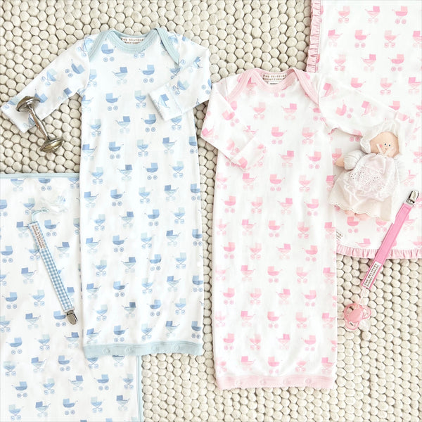 Two baby gowns in Blue Grand Gasparilla Gingham featuring carriage prints, paired with matching blankets, a doll, and two Parker Paci Clip - Blue Grand Gasparilla Gingham with Buckhead Blue sets.